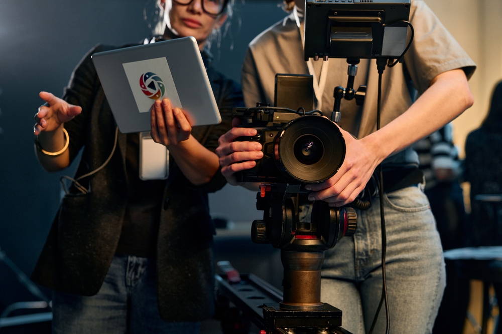 Font View Cropped Shot Of Two Women Operating Video Camera