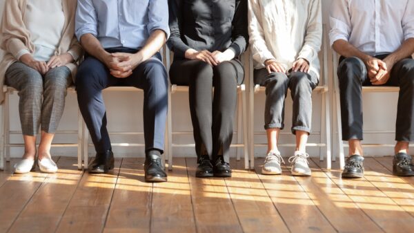 Diverse People Seated On Chairs In Row